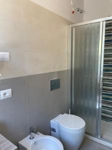 a bathroom with a toilet and a shower and a sink at Guerrini Hotel in Castiglioncello