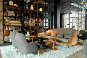 a store with chairs and a couch and a table at Motel One Hamburg-Fleetinsel in Hamburg