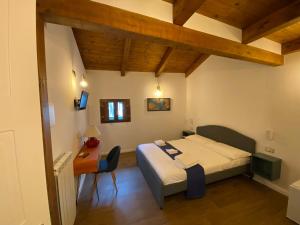 a bedroom with a bed and a desk with a table at B&B Vietri Centro in Vietri sul Mare