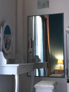 a bathroom with a mirror and a sink and a mirror at jasmine apartments in Eretria +38 photos