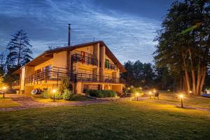 a large building with lights in the yard at night at Vila Ula in Perloja