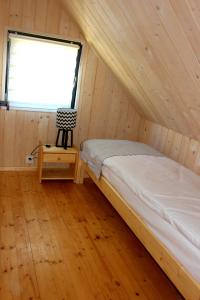 Domki Mazurskie Zacisze Jeziora Sunowo tesisinde bir odada yatak veya yataklar