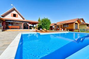 an image of a swimming pool in front of a house at Holiday Home Dika in Sveti Martin na Muri