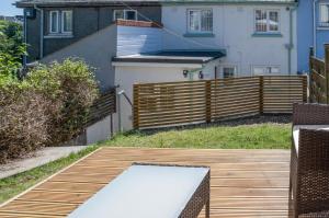 a wooden deck with a fence and a house at Newell Hill Cottage - 3 Bedroom Cottage - Tenby in Tenby