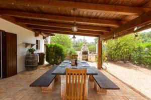 a wooden table and chairs on a patio at Tenuta Sardella by BarbarHouse in Latiano