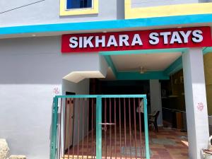 a building with a sign that reads skilaria stays at Newly opened - Sikhara Stays in Tirupati