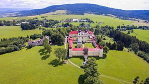 an aerial view of a large house on a green field at Hotel Zlatá Labuť in Králíky