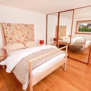 a bedroom with a large bed and a mirror at Shamerbrea The Foodie B&B in Inverness