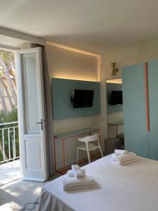 a hotel room with a bed and a balcony at Guerrini Hotel in Castiglioncello