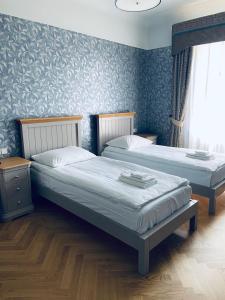 Posteľ alebo postele v izbe v ubytovaní Roze Republikas Apartments
