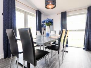 a dining room with a table and chairs at Box Tree Escapes in Lancaster