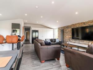 a living room with leather furniture and a fireplace at Box Tree Escapes in Lancaster