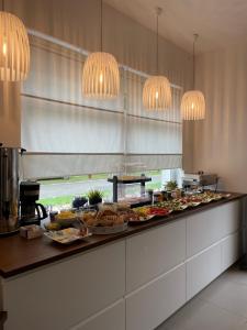 a buffet with many plates of food on a counter at Venezia De Luxe Dom Wypoczynkowy in Łeba