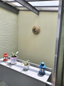 a window sill with three plants sitting on it at Maison exceptionnelle, Campagne a Paris in Paris