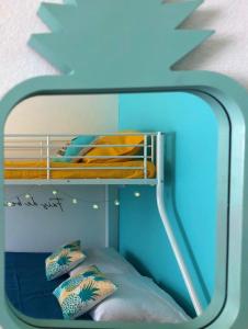 a reflection of a bunk bed in a mirror at Zandoli Cottage in Les Galets