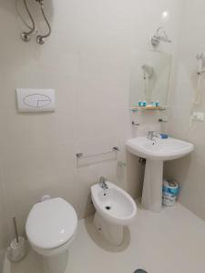 ein weißes Bad mit einem WC und einem Waschbecken in der Unterkunft Al porticciolo in Salerno