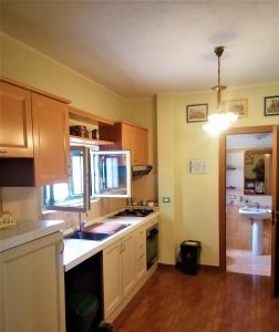 a kitchen with a sink and a stove top oven at CASA VACANZE, in centro città in Caltanissetta