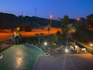 a backyard with a swimming pool at night at Il Nido Delle Rondini in Grottole