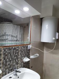 a bathroom with a sink and a mirror at Apart Ocampo Catamarca II in San Fernando del Valle de Catamarca