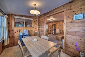 a dining room with a table and chairs at Riverfront Escape with Dock 19 Mi to Saratoga! in Lake Luzerne