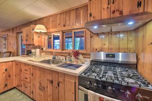 a kitchen with a stove and a sink at Riverfront Escape with Dock 19 Mi to Saratoga! in Lake Luzerne