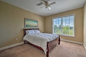 a bedroom with a bed and a ceiling fan at Bright Bayfront Home Less Than 2 Mi to Hernando Beach! in Hernando Beach +25 photos