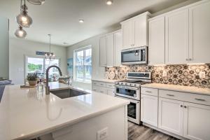 a kitchen with white cabinets and a counter top at Bright Bishops Landing Home Less Than 5 Miles to Beach! in Millville