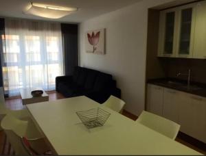 a living room with a white table and chairs at Apartment - 2 Bedrooms - 02447 in Malpica