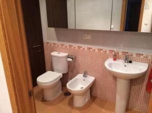 a bathroom with a toilet and a sink at Apartment - 2 Bedrooms - 02447 in Malpica