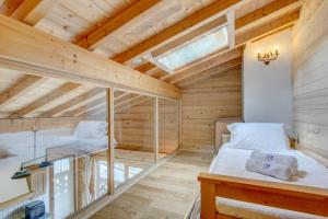 a room with two beds in a wooden house at Rose et Chardon Apartment - Snow and Trek - Morzine in Morzine