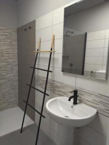 a bathroom with a sink and a mirror at Le Coltie - affittacamere e appartamenti in Venturina Terme