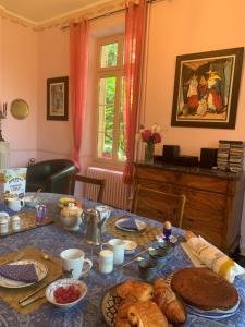 a table with bread and other food on it at France Petit Château in Loué