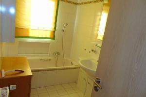 a bathroom with a tub and a sink and a shower at Haus Tanja in der Kurstadt Bad Eilsen in Bad Eilsen