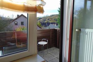 a sliding glass door with a chair on a balcony at Haus Tanja in der Kurstadt Bad Eilsen in Bad Eilsen