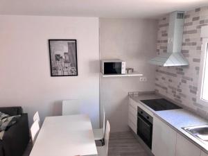 a small kitchen with a table and a microwave at C.R. Tierras del Cabriel in Minglanilla