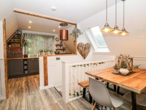 a kitchen and dining room with a wooden table and chairs at Lavender Lodge in Callington
