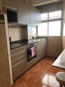 a kitchen with a stove with a towel on the oven at LAS CANTERAS in Las Palmas de Gran Canaria