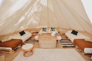 a room with two beds and a table in a tent at Cocooning Tipi - Seignosse in Seignosse +29 photos