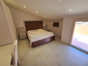 Ένα ή περισσότερα κρεβάτια σε δωμάτιο στο L'Isola nel Parco Boutique Rooms & Apartments