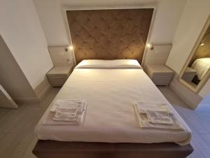Voodi või voodid majutusasutuse Isola nel Parco Villas & Rooms toas