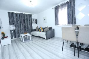 a living room with a bed and a dining table at Modern 2 Bedroom Flat, with Free Parking, and WIFI in Thamesmead