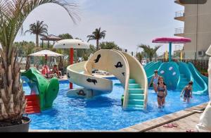 a group of people playing in a water park at BEA APARTAMENT ON THE BEACH -Mamaia Nord in Năvodari