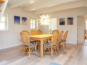 a dining room with a wooden table and chairs at 8 person holiday home in Vig in Vig