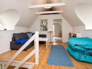 a living room with a loft bed and a couch at 8 person holiday home in Vig in Vig