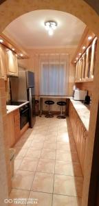 a kitchen with two stools in the middle of it at Vida vendégház in Hajdúszoboszló
