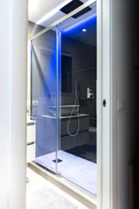 a bathroom with a shower with a glass door at InLuce Apartment Top Class in Sanremo