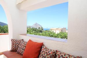 a couch sitting on a balcony with a large window at Country Villa San Vito Bay in San Vito lo Capo
