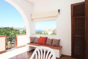 a balcony with a bench and a view of the ocean at Country Villa San Vito Bay in San Vito lo Capo
