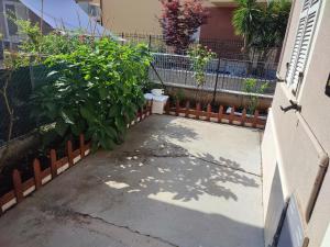a patio with a plant and a fence at Le Due Sorelle in Porto SantʼElpidio