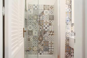 a shower with a glass door in a bathroom at Country Villa San Vito Bay in San Vito lo Capo